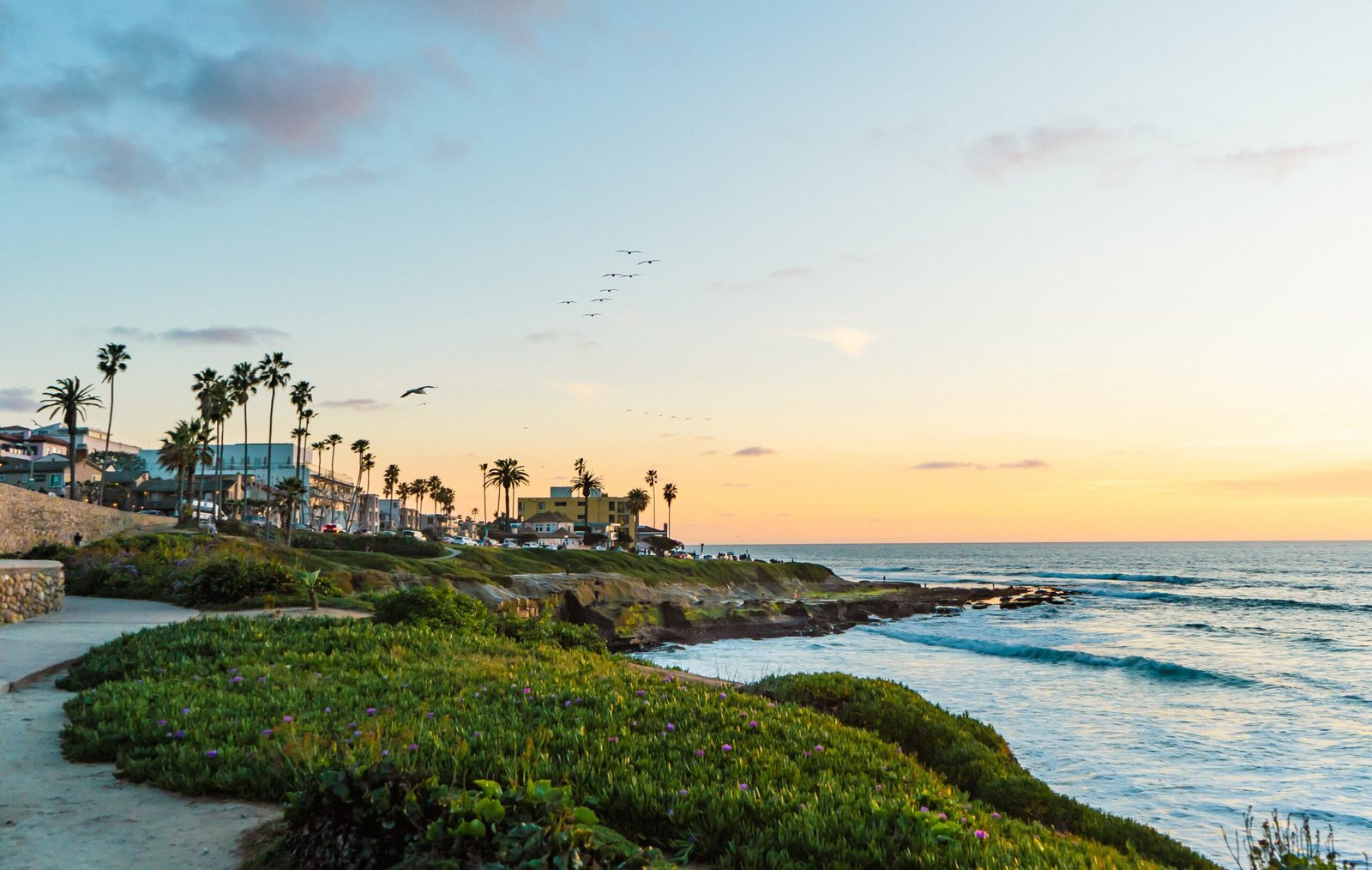A,Beautiful,Beach,Scene,With,Palm,Trees,And,A,Sunset